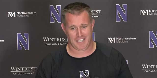 Pat Fitzgerald speaking at a press conference.
