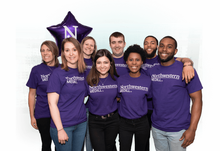 A group of students wearing purple shirts that say Northwestern Medill.