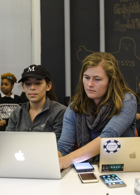 Two women working together at a laptop.