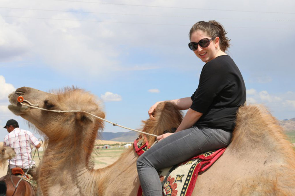 A student rides a camel
