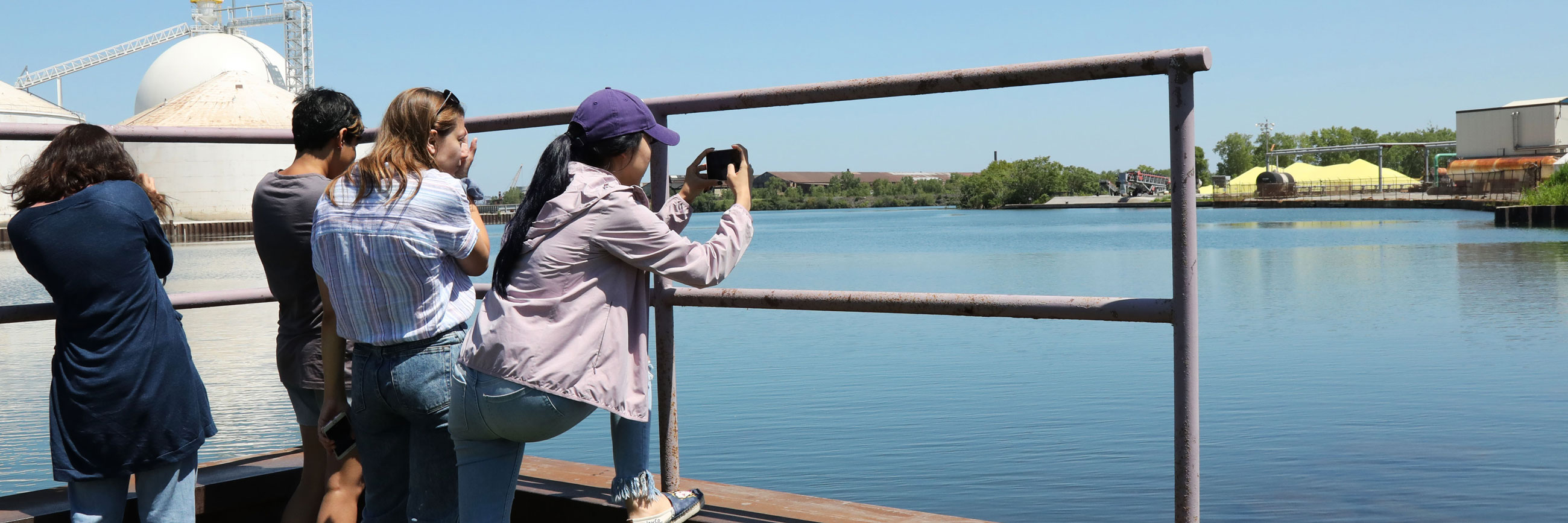 Student photographing a lake