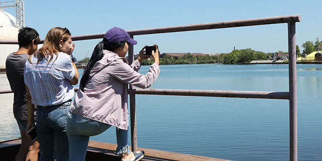 Students taking pictures of a lake
