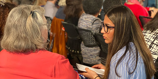 Student interviewing woman