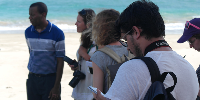 Student interview an expert by the ocean in Puerto Rico.