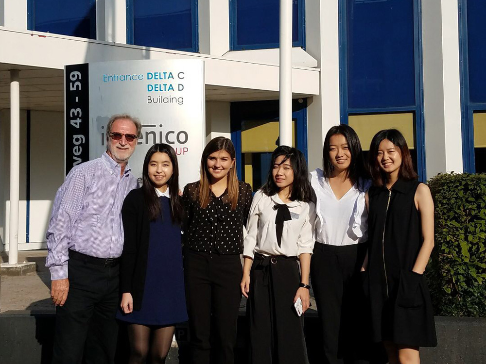 Five IMC Full-Time students from the Ingenico team pose for a photo with faculty member Tom Collinger outside of Ingenico's headquarters in Amsterdam