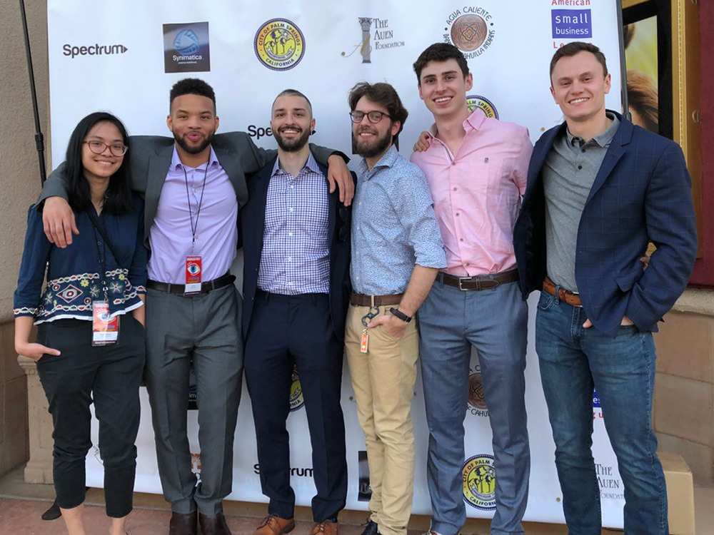 Six Medill students and alumni pose for a photo at the AmDocs Film Festival