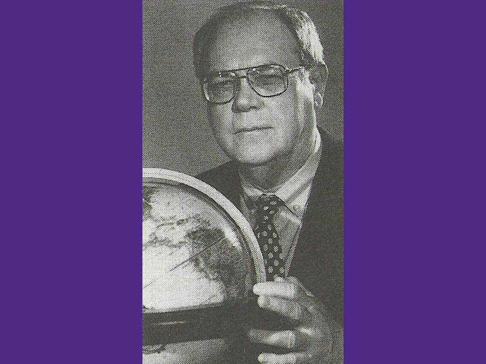In an old photo, Don Schultz appears next to a globe