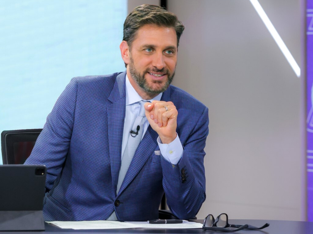 Mike Greenberg sitting at anchor desk.