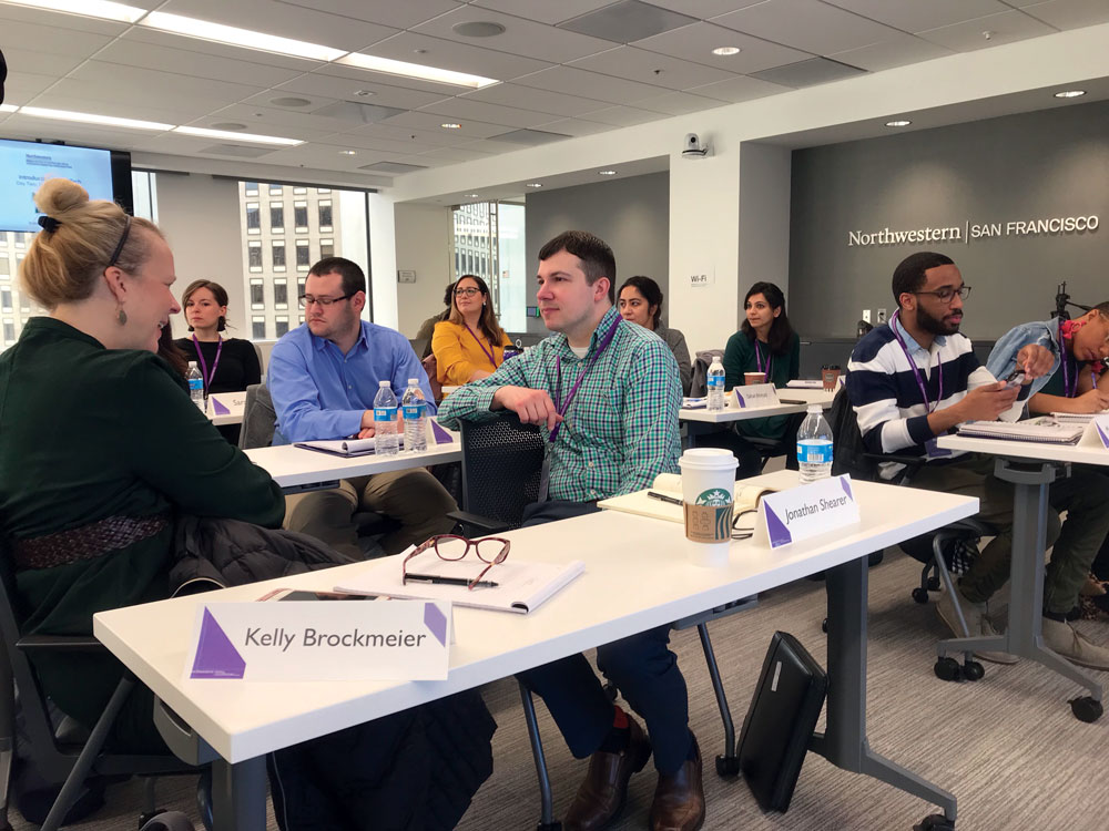 Students sit around a table and talk about MarTech