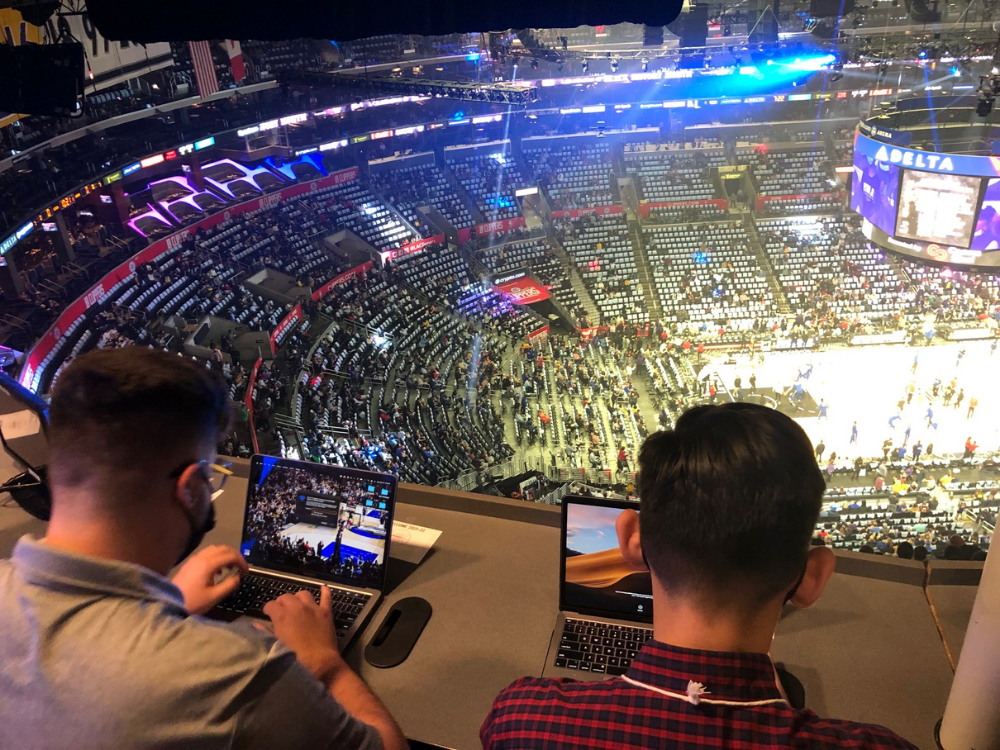 Students cover a basketball game in Los Angeles, California.