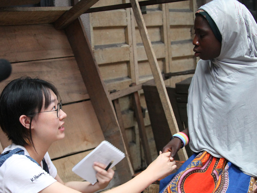 A reporter reaches out to shake the hand of someone she is interviewing