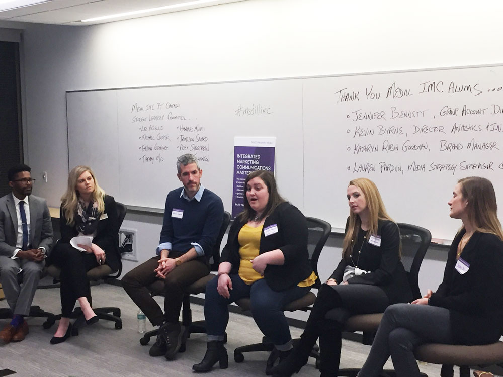 Two Medill IMC students and four alumni sit at the front of a room and participate in a panel conversation