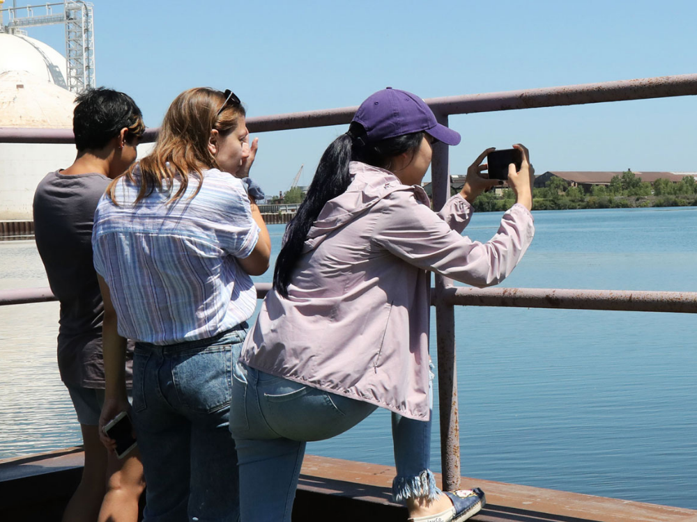 Students photographing a lake