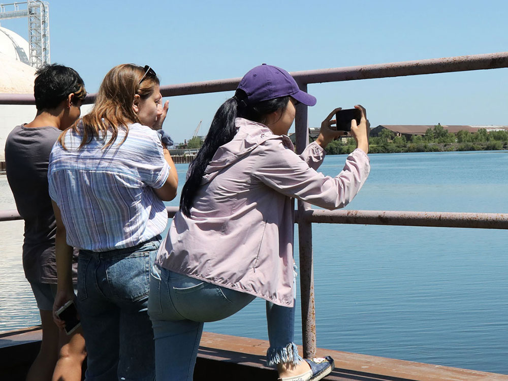 Students photographing a lake