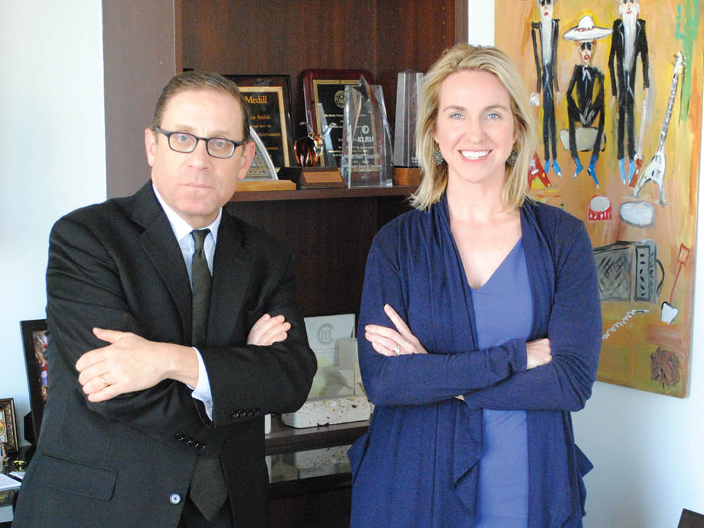 Texas Tribune Co-Founder and CEO Evan Smith and Editor-in-Chief Emily Ramshaw pose for a photo at the Texas Tribune office