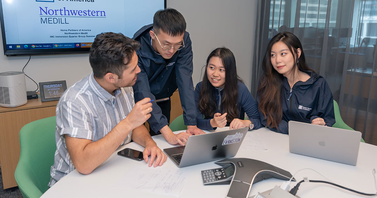 Immersion Quarter students collaborating around a table.