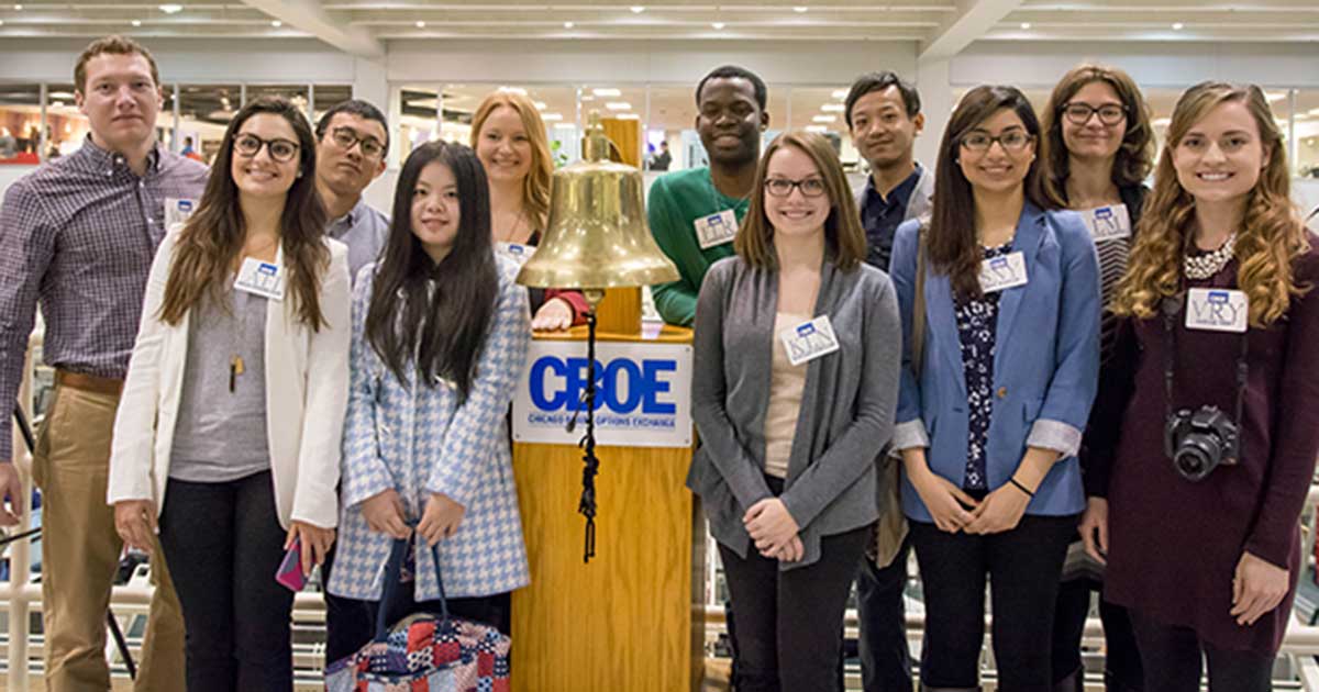 Students standing next to the CBOE bell.