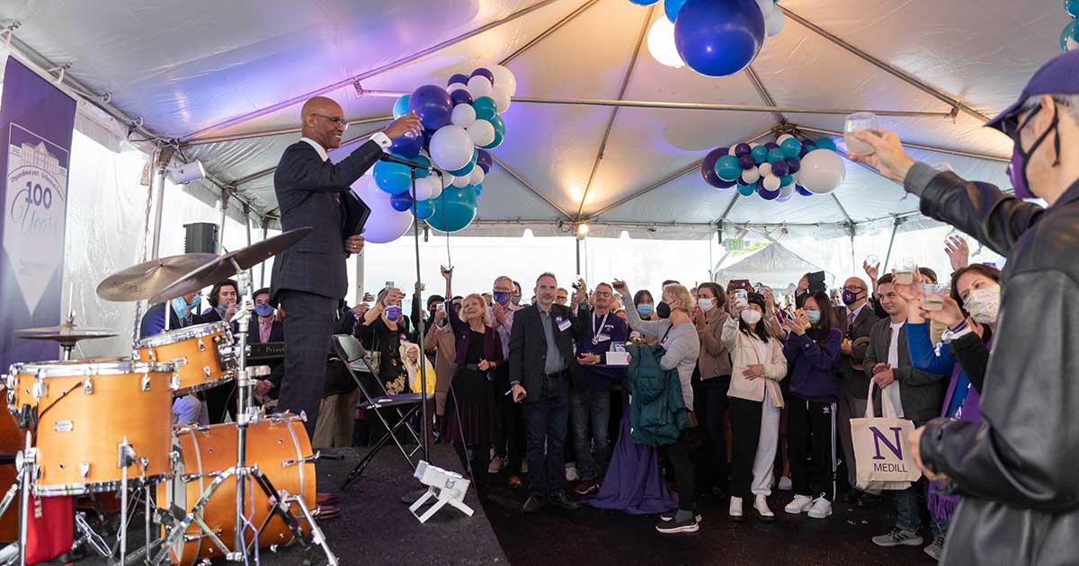 Dean Whitaker gives a toast to a crowd of people at the Medill Centennial Celebration.