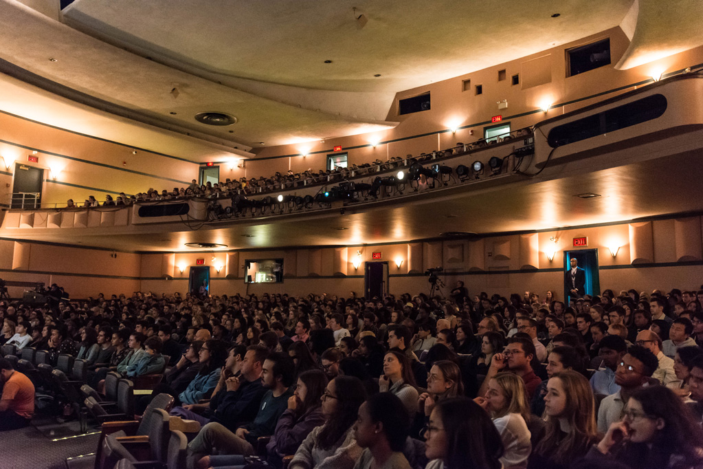 Photo taken of the crowd and full seats filled with students in Cahn Auditorium
