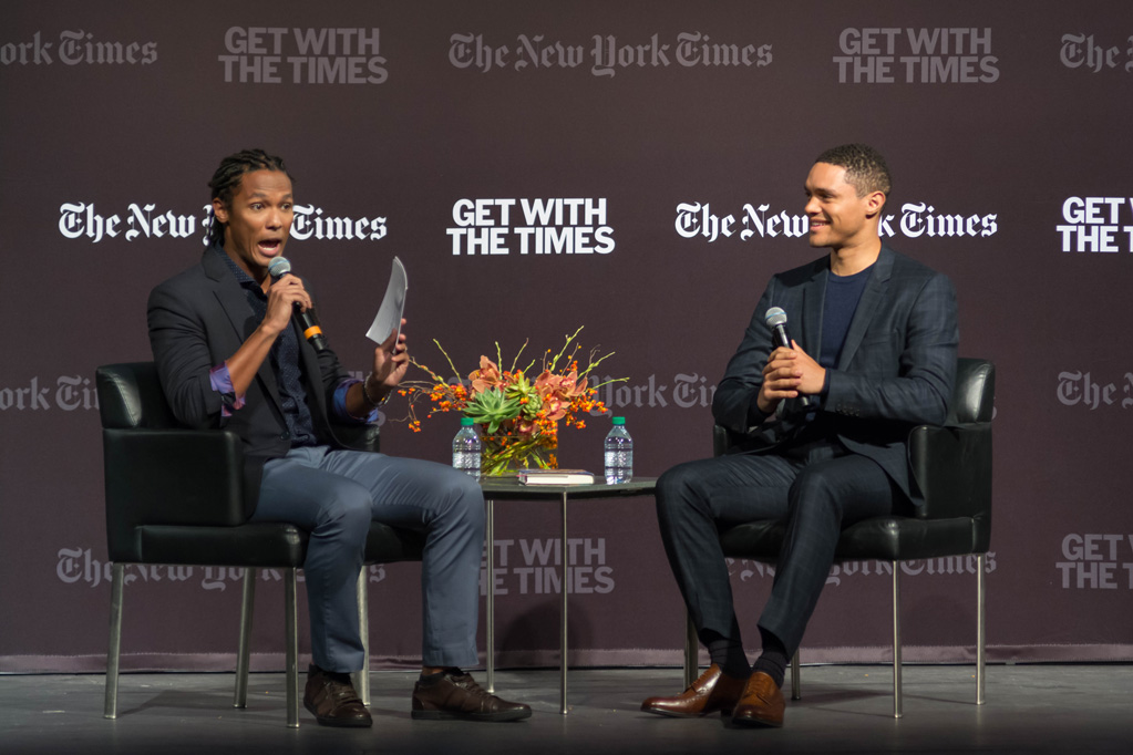 Medill alumnus John Eligon asks Trevor Noah a question on stage