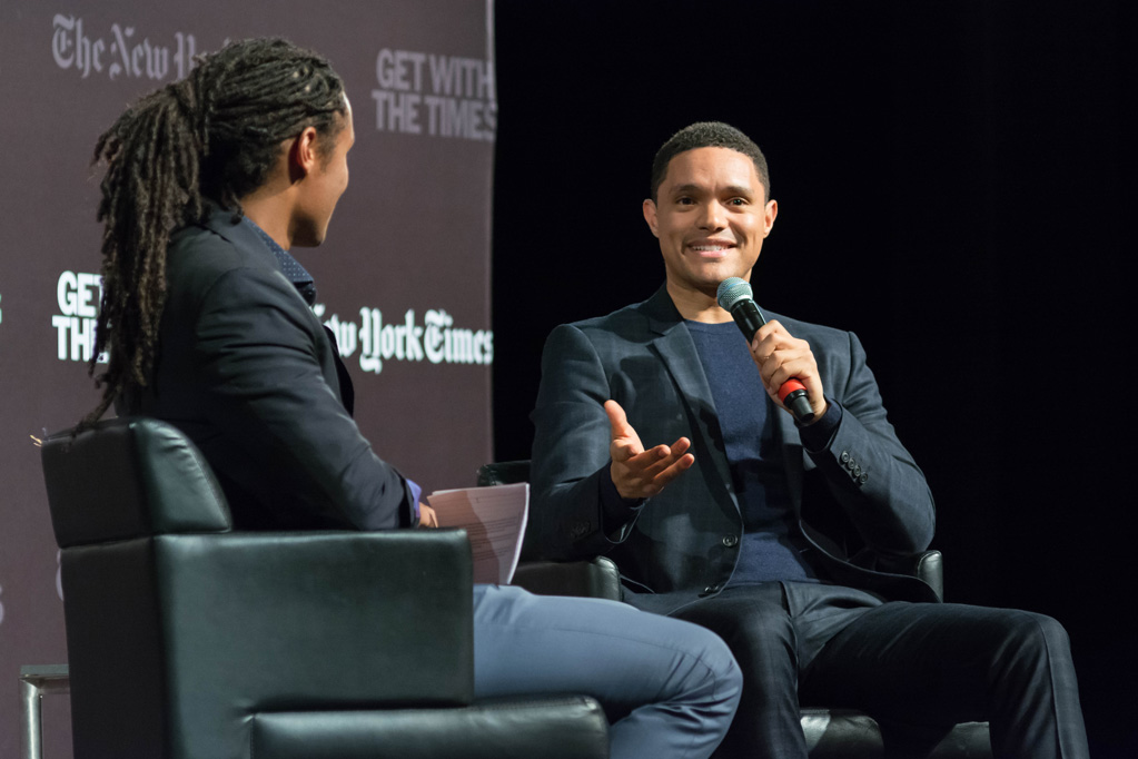 Trevor Noah speaks on stage with Medill alumnus John Eligon