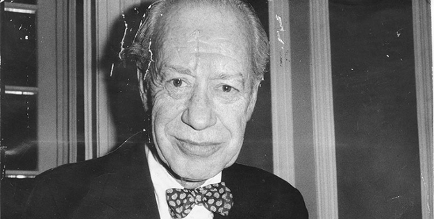 Black and white photo of John Bartlow Martin wearing a suite and bowtie. 