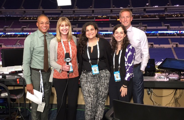 IMC Certificate students in the announcers' booth at a football stadium.