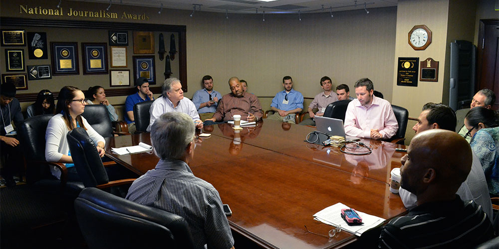 Students sit in on an editorial meeting at the Orlando Sentinel