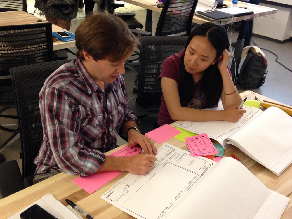 Two students work on a design exercise during class