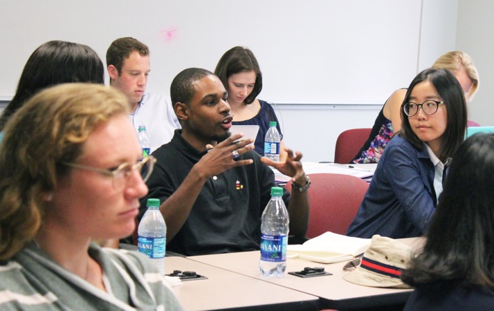 A Medill student asks a question of the presenters at the health care reporting conference