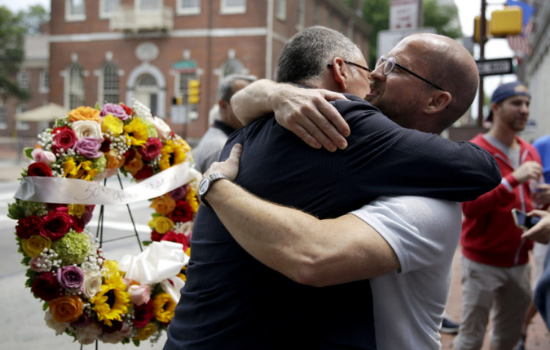 Jim Obergefell, left, the man behind the landmark Supreme Court gay marriage ruling, hugs Jeff Sigler of New York, after laying a wreath at the Gay Pioneers historical marker across from Independence Hall in Philadelphia in 2015. AP Photo/Matt Slocum