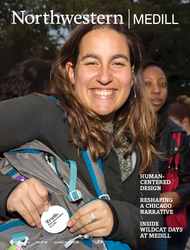 Medill Magazine Issue 98 - a female student points to a button on her backpack and smiles to the camera